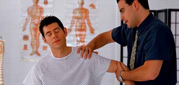 Chiropractor performing a shoulder adjustment on a patient